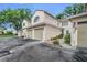 Exterior view of a townhouse showcasing the attached garage and neutral color palette at 3030 Clubview Dr # Ge, Orlando, FL 32822