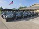 A fleet of golf carts lined up outside with clear blue skies and lush green surroundings, ready for a day on the course at 3030 Clubview Dr # Ge, Orlando, FL 32822