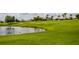 Scenic golf course with pond and green grass, blending natural beauty with recreational amenities at 3030 Clubview Dr # Ge, Orlando, FL 32822