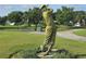Golf statue on the golf course, complete with green landscaping and blue flowering plants in the foreground at 3030 Clubview Dr # Ge, Orlando, FL 32822