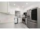 A modern kitchen with stainless steel appliances and white cabinetry at 3030 Clubview Dr # Ge, Orlando, FL 32822