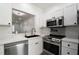 A kitchen shows stainless steel appliances, white cabinets and a black faucet at 3030 Clubview Dr # Ge, Orlando, FL 32822