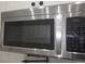 Close-up of a stainless steel LG microwave with gray backsplash and white cabinets at 3030 Clubview Dr # Ge, Orlando, FL 32822