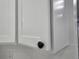 Close up view of a well-maintained white kitchen cabinet featuring a round black knob at 3030 Clubview Dr # Ge, Orlando, FL 32822