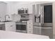 Modern kitchen featuring stainless steel appliances, white cabinets, and quartz countertops at 3030 Clubview Dr # Ge, Orlando, FL 32822