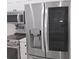 Close-up of a stainless steel LG refrigerator with a water dispenser in a modern kitchen at 3030 Clubview Dr # Ge, Orlando, FL 32822