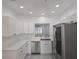 Bright kitchen features white cabinets, stainless steel appliances, and modern countertops at 3030 Clubview Dr # Ge, Orlando, FL 32822