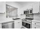 Bright kitchen features stainless steel appliances, white cabinetry, and a stylish tiled backsplash at 3030 Clubview Dr # Ge, Orlando, FL 32822