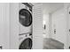 Efficient laundry closet with stacked washer and dryer, neatly tucked away near the entryway at 3030 Clubview Dr # Ge, Orlando, FL 32822