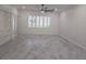 Spacious living room with tile flooring, shutters and built-in shelving at 3030 Clubview Dr # Ge, Orlando, FL 32822