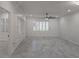 Large living room with gray tile floors, built-in shelving, and plantation shutters at 3030 Clubview Dr # Ge, Orlando, FL 32822