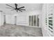 Spacious living room with large windows, ceiling fan and gray tile floor at 3030 Clubview Dr # Ge, Orlando, FL 32822