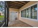 Screened-in patio with wood-look tile, exterior sliding door, and a view of the manicured exterior at 3030 Clubview Dr # Ge, Orlando, FL 32822