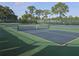 Well-maintained tennis courts with green and blue surfaces, nets in place, and lush green surroundings at 3030 Clubview Dr # Ge, Orlando, FL 32822