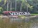 The Ventura sign surrounded by palm trees and greenery on the water at 3030 Clubview Dr # Ge, Orlando, FL 32822