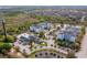 Aerial view of apartment complex with a pond, pool and many trees at 3176 Feltrim Pl # 302, Kissimmee, FL 34747