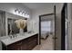 Elegant bathroom featuring a double vanity, modern lighting, and stylish fixtures at 3176 Feltrim Pl # 302, Kissimmee, FL 34747