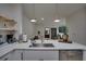 Open concept kitchen with a large island, stainless steel appliances, and pendant lighting at 3176 Feltrim Pl # 302, Kissimmee, FL 34747