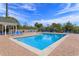 Community pool with lounge chairs under sunny skies, creating a relaxed recreational space at 3176 Feltrim Pl # 302, Kissimmee, FL 34747