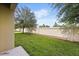 Private backyard with a well-maintained lawn and a sturdy fence offers peace and seclusion at 3537 Seneca Club Loop # B, Orlando, FL 32808
