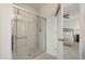 Bathroom featuring a stand-up shower with glass door and bedroom in the background at 3537 Seneca Club Loop # B, Orlando, FL 32808
