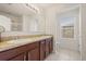 Bathroom features double sink vanity, large mirror, tiled floors, and separate toilet area at 3537 Seneca Club Loop # B, Orlando, FL 32808