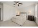 Bedroom featuring ceiling fan, neutral bedding, and dark wood nightstands with lamps at 3537 Seneca Club Loop # B, Orlando, FL 32808