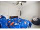 Bedroom features a ceiling fan, window, bed with blue space-themed bedding, and Star Wars decor at 3537 Seneca Club Loop # B, Orlando, FL 32808