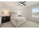 Bedroom features two windows, ceiling fan, and neutral bedding with dark wood furniture at 3537 Seneca Club Loop # B, Orlando, FL 32808