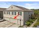 Townhouse with a three-car garage, black shutters, and a well-kept lawn offering suburban charm at 3537 Seneca Club Loop # B, Orlando, FL 32808