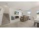 Open concept living room with stair access featuring neutral carpet, natural light, and comfortable seating at 3537 Seneca Club Loop # B, Orlando, FL 32808