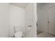 Clean powder room with a toilet, toilet paper holder, and nearby doorway to another room at 3537 Seneca Club Loop # B, Orlando, FL 32808