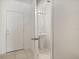 Neat powder room with pedestal sink illuminated by modern vanity lights, near the front door at 3537 Seneca Club Loop # B, Orlando, FL 32808