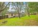 Large backyard with mature trees and a glimpse of the screened-in pool at 3954 Old Dunn Rd, Apopka, FL 32712
