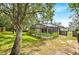 Spacious backyard with lush greenery and a screened pool area at 3954 Old Dunn Rd, Apopka, FL 32712