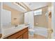 Bathroom with tiled floor, a vanity and tub/shower combo with a white curtain and window at 3954 Old Dunn Rd, Apopka, FL 32712