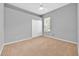 Carpeted bedroom features a ceiling fan, a window providing natural light, and a closet for storage at 3954 Old Dunn Rd, Apopka, FL 32712