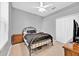 Neutral bedroom featuring carpet, ceiling fan, iron bed frame and natural light at 3954 Old Dunn Rd, Apopka, FL 32712