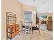 Cozy dining area featuring a round table and seating, complemented by a decorative storage unit at 3954 Old Dunn Rd, Apopka, FL 32712