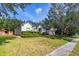 Well-maintained one-story home with manicured lawn, shrubbery and a two-car garage at 3954 Old Dunn Rd, Apopka, FL 32712