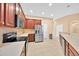 Bright kitchen featuring stainless steel appliances, tiled flooring, and dark wood cabinets at 3954 Old Dunn Rd, Apopka, FL 32712