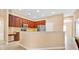 Bright open concept kitchen offering stainless steel appliances, tiled flooring, and dark wood cabinets at 3954 Old Dunn Rd, Apopka, FL 32712