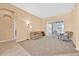 Bright living room featuring neutral paint, plush carpeting, and sliding glass doors at 3954 Old Dunn Rd, Apopka, FL 32712