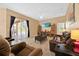 Spacious living room with sliding doors to patio, plush carpeting, and modern decor at 3954 Old Dunn Rd, Apopka, FL 32712