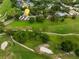 Breathtaking aerial view of a home overlooking a lush green golf course in a well-maintained community at 3966 Villas Green, Longwood, FL 32779