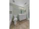 Well-lit bathroom with tile floors, a white vanity, and a combination shower and tub at 3966 Villas Green, Longwood, FL 32779