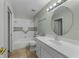 Bathroom with neutral tiling and white vanity with a large mirror at 3966 Villas Green, Longwood, FL 32779