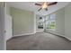 Large bedroom with a fan and a set of windows that overlook the yard at 3966 Villas Green, Longwood, FL 32779