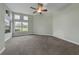 Spacious bedroom with large windows, neutral carpet, and ceiling fan at 3966 Villas Green, Longwood, FL 32779