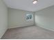 Bedroom featuring a window for natural light and neutral carpeting at 3966 Villas Green, Longwood, FL 32779